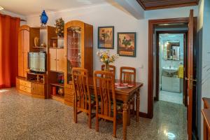 a dining room with a wooden table and chairs at Brisa de Sesimbra - Spacious Family Apartment, 5min Walk to the Beach with Private Parking in Sesimbra