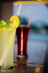 two drinks on a table with a lime and a drink at Blue Sea Explorer in Male City