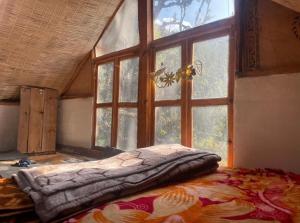 a bed in a room with a large window at Kasba Homes in Kalgha
