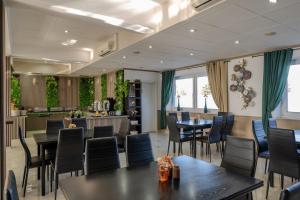 a restaurant with tables and chairs and a bar at Hotel Schöne Altmark in Kalbe
