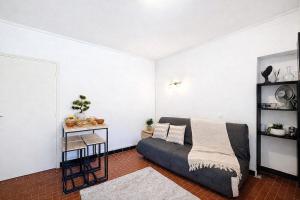 a living room with a couch and a table at Le Nid d'andéol in Bourg-Saint-Andéol