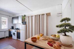 a kitchen with a table with a plate of food on it at Le Nid d'andéol in Bourg-Saint-Andéol