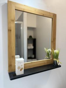 a mirror on a shelf with a box on it at Le Nid d'andéol in Bourg-Saint-Andéol