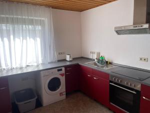 a kitchen with a washing machine and a sink at Gästeapartment in ruhiger Lage in Rainau