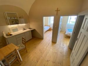 a room with a table and a cross on the wall at Klášter Nová Říše in Nová Říše