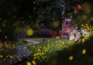 a person riding a bike in a park with flowers at 岩川森林民宿 Springcreek B&B in Zhuolan