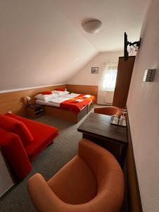 a hotel room with a bed and a desk and chairs at Pension Euro in Mikulov