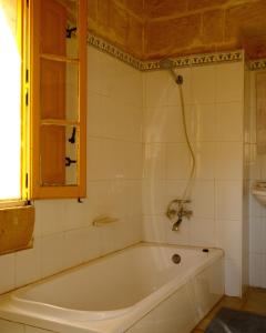 a bath tub in a bathroom with a window at L'Artiste Guest House in Xagħra +20 photos