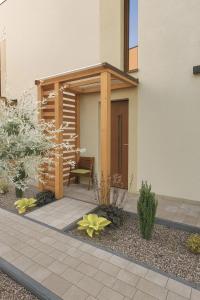 a house with a patio with a bench in front of it at Bursztynowy Horyzont Śliwin obok Rewal , Pobierowo in Śliwin