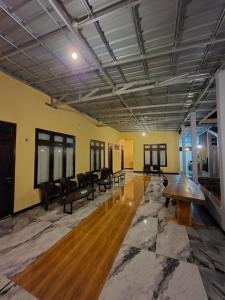 a large room with couches and tables in it at d'Alvin Homestay 2 in Labuan Bajo