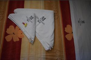 two white towels are hanging on a wall at Villa Miranda in Keri +61 photos