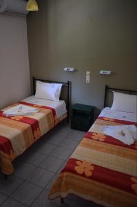 two beds sitting next to each other in a room at Villa Miranda in Keri
