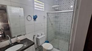 a bathroom with a toilet and a sink and a shower at Pousada Maresia in São Miguel dos Milagres +59 photos