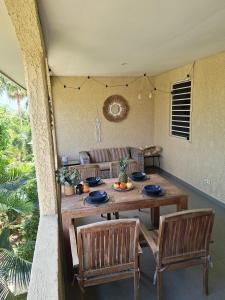 a wooden table and chairs in a living room at CocoCasa 22 Stylish Luxury Apartment with Pool near Jan Thiel Beach in Willemstad