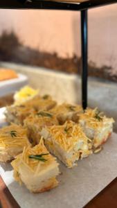 a bunch of food on a plate with cheese at Linhares Design Hotel in Linhares