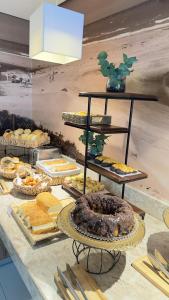 a buffet with many different types of bread and pastries at Linhares Design Hotel in Linhares +75 photos