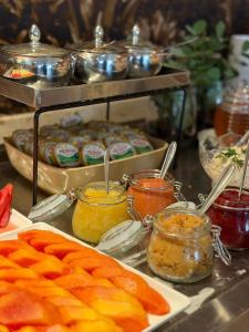 a buffet with jars of pickles and other food at Linhares Design Hotel in Linhares