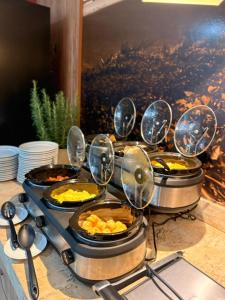 a bunch of pans of food on a stove at Linhares Design Hotel in Linhares