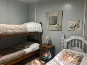 a bedroom with two bunk beds and a mirror at Chacra La Escondida in Colonia del Sacramento +291 photos