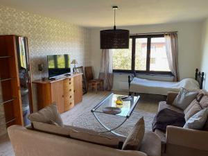 a living room with a couch and a table at Fjordhotellet in Lysekil