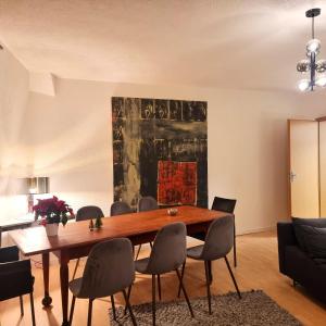 a dining room with a wooden table and chairs at Apartment am Rathaus in Quedlinburg