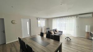 a living room with a table and a couch at les jumelles villa 1 in Saint-Gaudens