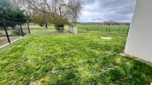 a view of a field with a fence and grass at les jumelles villa 1 in Saint-Gaudens