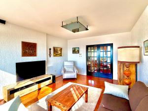 a living room with a couch and a tv at Blue View Apartment in Opatija +22 photos