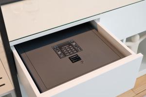 a tablet in a drawer of a desk at Rosário Suites Townhouse in Porto