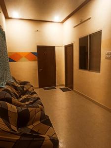 an empty room with a bed and some doors at skyparking Golden cottage in Salem