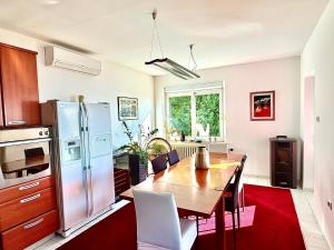 a kitchen with a wooden table and a refrigerator at Blue View Apartment in Opatija