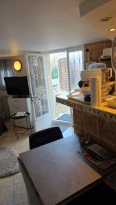 a kitchen with a table and a counter top at Studio atypique avec Piscine à partager en option in La Ferté-Gaucher