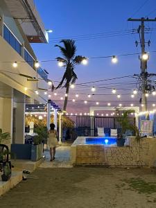 a woman walking into a building at night at Palmarena in Puerto Viejo +11 photos