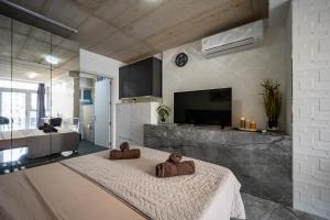 a living room with a large bed in a room at Seafront, lovely modern studio. in St. Julianʼs