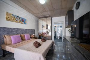 a bedroom with a large bed with two teddy bears on it at Seafront, lovely modern studio. in St. Julianʼs +12 photos