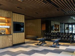 a gym with two pairs of dumbbell chairs in a building at Sofitel Adelaide in Adelaide