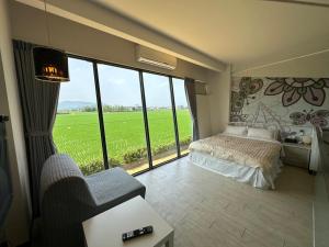 a bedroom with a bed and a large window at Lan Yang Resort Four Seasons in Dongshan +33 photos