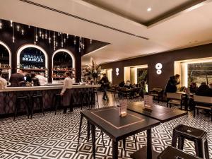 a restaurant with people sitting at a bar at Mercure Lugo Centro in Lugo +63 photos