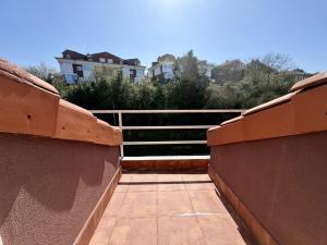 a view of a balcony with a fence and buildings at Apartamento Somo 30608 in Somo