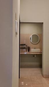 a bathroom with a sink and a mirror at azafa hotel in Lamobuang