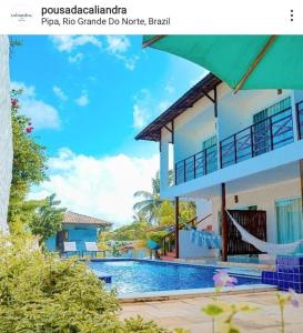 a picture of a house with a swimming pool at Pousada Caliandra Pipa in Pipa