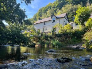a house on the side of a river at Rockford Cottage Brendon in Countisbury