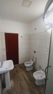 a bathroom with a white toilet and a sink at rocky in Concordia +3 photos