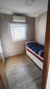 a small bedroom with a bed and a window at rocky in Concordia