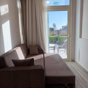 a living room with a couch and a large window at Porto View in Hurghada