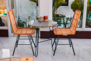 a table with two chairs and a table with two cups on it at New Modern Summer House in Moalboal +20 photos