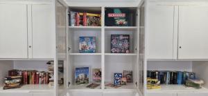 a white book shelf filled with lots of books at 1, 2, sleep Hostel Nürnberg Messe in Nuremberg