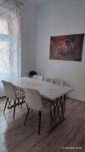 a white table and chairs in a room at Apartments Angels o k b S2 in Altenburg