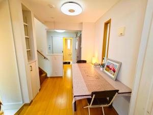 a room with a table with a picture on it at Ueno 10minutes, Tokyo University 10minutes, three BR, three toilets, Max 10 people Free parking in Tokyo