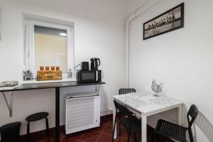 a kitchen with a table and a table and chairs at LénApartman - Holiday in Pécs